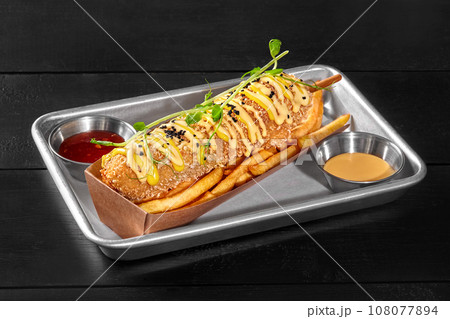 Smoked sausage corn dog with french fries, sweet chili and cheddar sauces 108077894