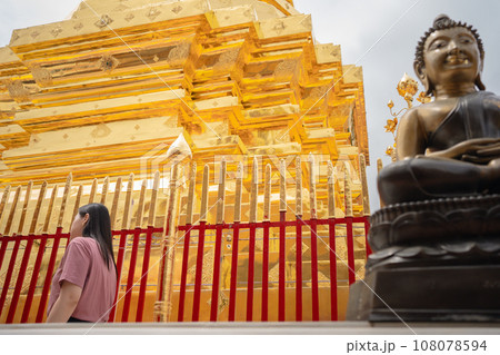 asian woman travel and see to gold temple at chiangmai Thailand in summer season asian woman travel and see to gold temple at chiangmai Thailand in summer season 108078594