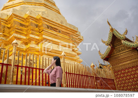 asian woman travel and see to gold temple at chiangmai Thailand in summer season asian woman travel and see to gold temple at chiangmai Thailand in summer season 108078597