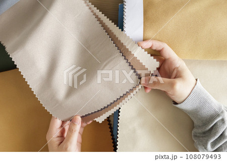 female designer with fabric color samples choosing textile for curtains 108079493