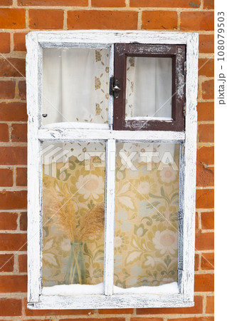 Old vintage wooden window on old brick wall. Retro style 108079503