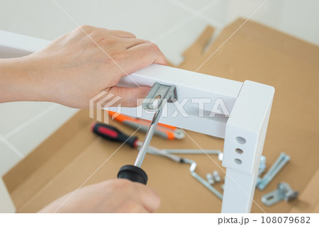 Assembly furniture using screwdriver at home Assembly furniture using screwdriver at home 108079682