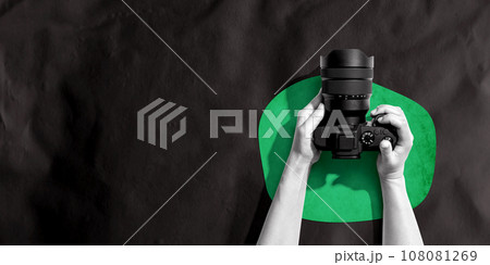 Person holding a SLR camera 108081269