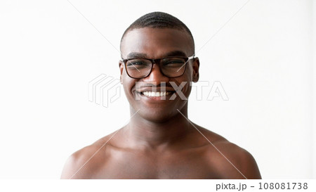 Male skincare. Face moisturizing. Health wellbeing. Amused masculine shirtless man in glasses enjoying smooth soft skin toothy smile isolated on white background. Male skincare. Face moisturizing. Health wellbeing. Amused masculine shirtless man in glasses enjoying smooth soft skin toothy smile isolated on white background. 108081738