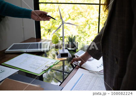 A sales representative presenting solar and wind power, alternative energy, clean energy for future. A sales representative presenting solar and wind power, alternative energy, clean energy for future. 108082224