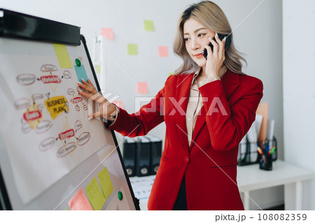 Business planning, portrait of a business woman using a computer to audit financial statements and marketing. 108082359