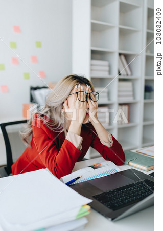 Portrait of business owner, woman using computer and financial statements Anxious expression on expanding the market to increase the ability to invest in business. Portrait of business owner, woman using computer and financial statements Anxious expression on expanding the market to increase the ability to invest in business. 108082409