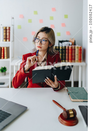 Portrait of a Asian woman lawyer studying a lawsuit for a client before going to court. 108082417