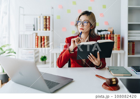 Portrait of a Asian woman lawyer studying a lawsuit for a client before going to court. Portrait of a Asian woman lawyer studying a lawsuit for a client before going to court. 108082420