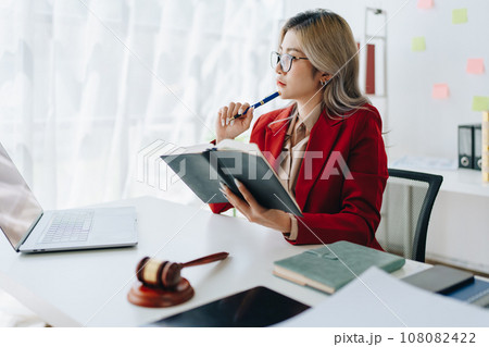 Portrait of a Asian woman lawyer studying a lawsuit for a client before going to court. 108082422