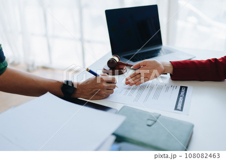 The lawyer with a client discussing contract paper, a Business lawyer working about legal legislation in the courtroom to help their customer, contract and agreement concept 108082463