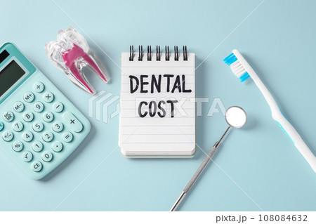 Dental cost concept, dentist tool, tooth with calculator on blue background, top view 108084632