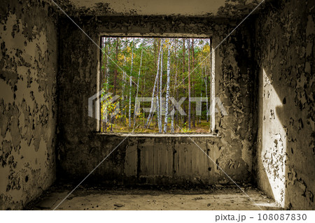 View through the hole for a windows in a damaged abandoned panel house. View through the hole for a windows in a damaged abandoned panel house. 108087830
