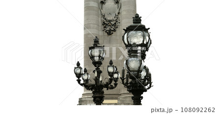 Lamp posts on Alexander III Bridge (carved on white background). Paris, France. This arch bridge is one of the most beautiful river crossings in the world Lamp posts on Alexander III Bridge (carved on white background). Paris, France. This arch bridge is one of the most beautiful river crossings in the world 108092262