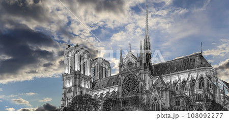 Notre Dame de Paris (against the background of sky with clouds), also known as Notre Dame Cathedral or simply Notre Dame, is a Gothic, Roman Catholic cathedral of Paris, France Notre Dame de Paris (against the background of sky with clouds), also known as Notre Dame Cathedral or simply Notre Dame, is a Gothic, Roman Catholic cathedral of Paris, France 108092277