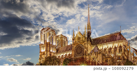 Notre Dame de Paris (against the background of sky with clouds), also known as Notre Dame Cathedral or simply Notre Dame, is a Gothic, Roman Catholic cathedral of Paris, France 108092279