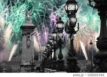 Celebratory colorful fireworks over the Lamp posts on Alexander III Bridge. Paris, France. This arch bridge is one of the most beautiful river crossings in the world Celebratory colorful fireworks over the Lamp posts on Alexander III Bridge. Paris, France. This arch bridge is one of the most beautiful river crossings in the world 108092566
