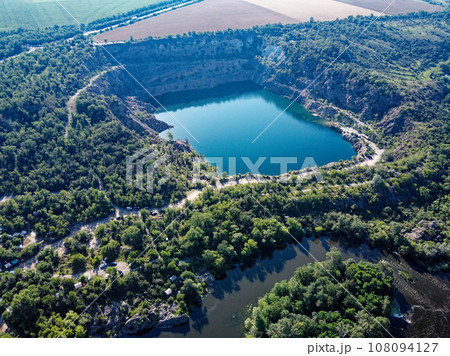 Radon lake near the Southern Bug river on a sunny summer day. Picturesque landscape from a bird's eye view. Flooded granite quarry. 108094127