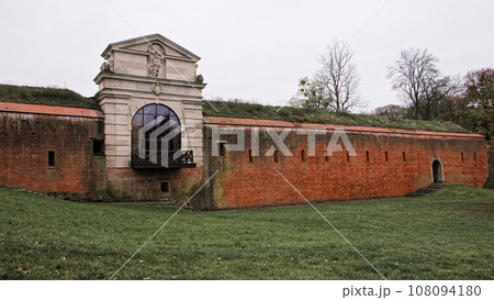 Old Lublin gate (Brama Lubelska) of fortress in Zamosc, Poland. Ancient fortification brick wall. 108094180