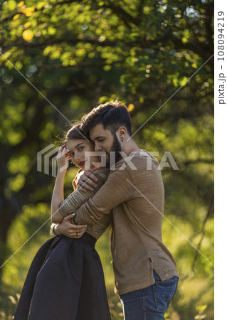 young couple hugging in nature young couple hugging in nature 108094219