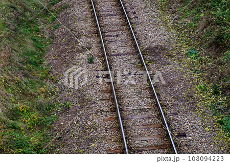 Railway bed. Fragment of railway tracks, top view, rails and sleepers. 108094223
