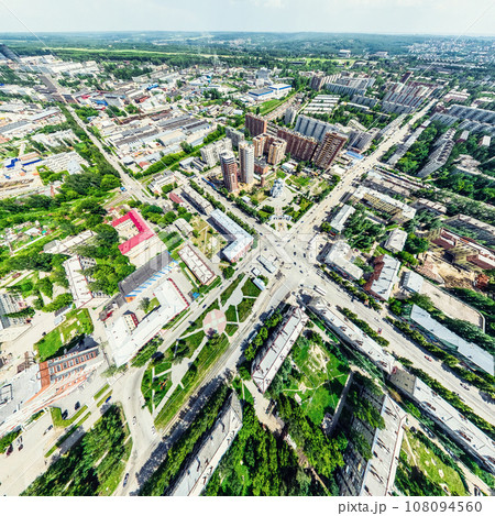 Aerial city view with crossroads and roads, houses, buildings, parks and parking lots. Sunny summer panoramic image Aerial city view with crossroads and roads, houses, buildings, parks and parking lots. Sunny summer panoramic image 108094560