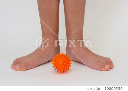 Cropped child legs and spiky needle ball Cropped child legs and spiky needle ball 108095504