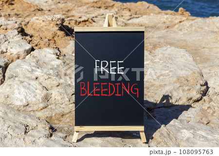 Free bleeding symbol. Concept words Free bleeding on beautiful black chalk blackboard. Beautiful stone sea blue background. Gen Z, motivational, freedom free bleeding concept. Copy space. Free bleeding symbol. Concept words Free bleeding on beautiful black chalk blackboard. Beautiful stone sea blue background. Gen Z, motivational, freedom free bleeding concept. Copy space. 108095763
