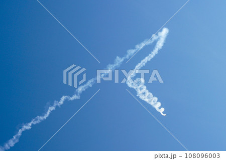 Aerobatic plane performing a multiple corkscrew maneuver leaving a smoke trail Aerobatic plane performing a multiple corkscrew maneuver leaving a smoke trail 108096003