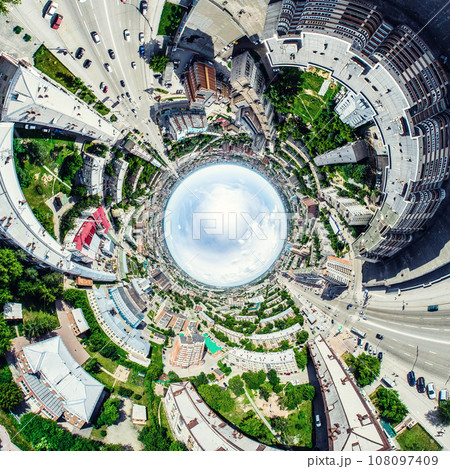 Aerial city view with crossroads and roads, houses, buildings, parks and parking lots. Sunny summer panoramic image 108097409