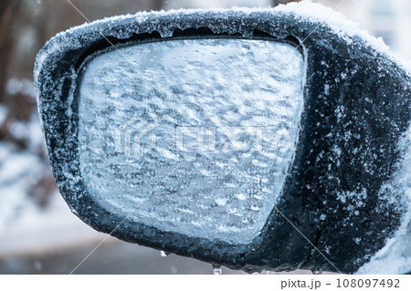 car covered with ice after snowstorm car covered with ice after snowstorm 108097492