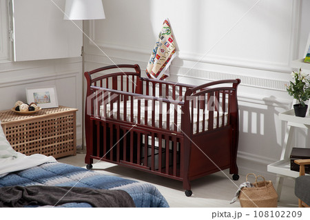 cozy bedroom with baby bed and lamp 108102209