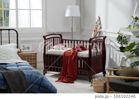 cozy bedroom with baby bed and lamp 108102240
