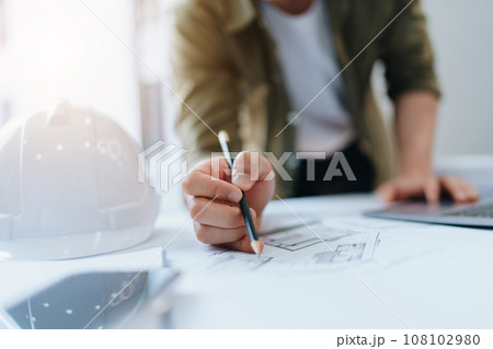 engineering department with work design structure building or house using blueprint computer at workin 108102980