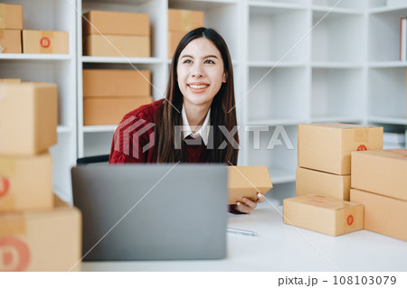 Asian female business owner handles delivery of orders to customers. 108103079