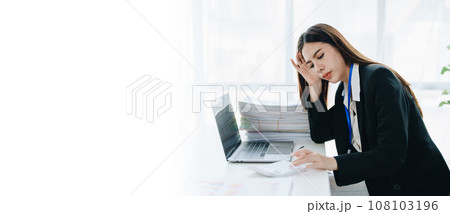 Portrait of business owner, woman using computer and financial statements Anxious expression on expanding the market to increase the ability to invest in business. 108103196