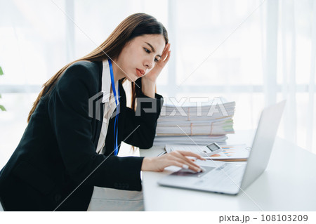 Portrait of business owner, woman using computer and financial statements Anxious expression on expanding the market to increase the ability to invest in business. 108103209