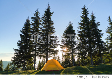Tourist camping tent on mountain campsite at bright sunny evening. Active tourism and hiking concept 108104985