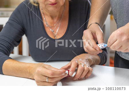 Male hands prepare blood lamcets for woman 108110073