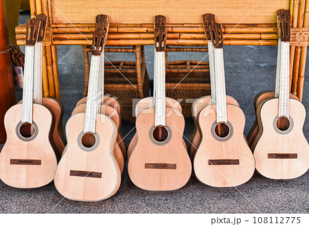 Many unfinished wooden drying guitars in workshop Many unfinished wooden drying guitars in workshop 108112775