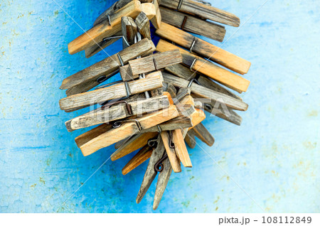 Clothespins on a rope on a blue shabby wall background.  108112849