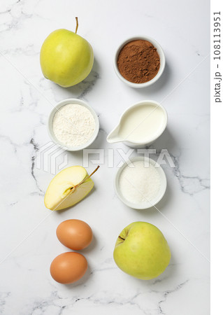 The ingredients are laid out on the table for preparing autumn pastries. 108113951