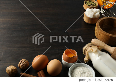 The ingredients are laid out on the table for preparing autumn pastries. 108113970