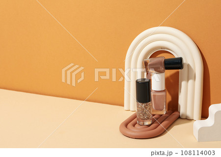 Nail polishes with decorations on a light background 108114003