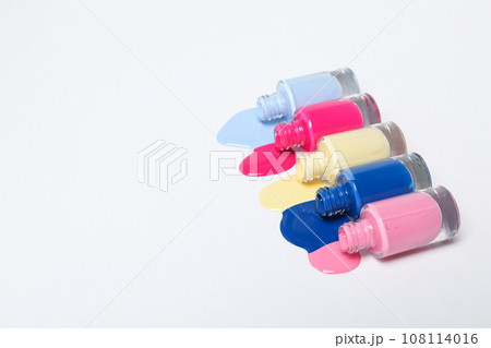 Multicolored open nail polishes on a white background 108114016