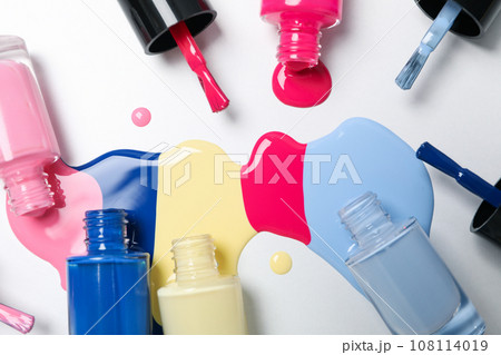 Multicolored open nail polishes on a white background Multicolored open nail polishes on a white background 108114019