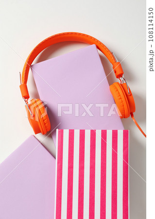 Headphones on books on white background, top view 108114150