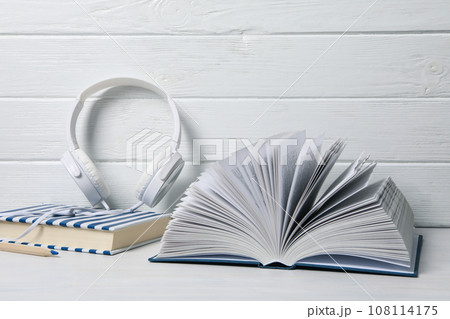 Headphones, books and pencil on white wooden background Headphones, books and pencil on white wooden background 108114175