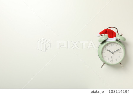 A clock with a Santa hat with a New Year's decoration. 108114194