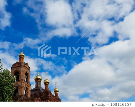 Domes of the church on the background of a blue sky with clouds Domes of the church on the background of a blue sky with clouds 108116157